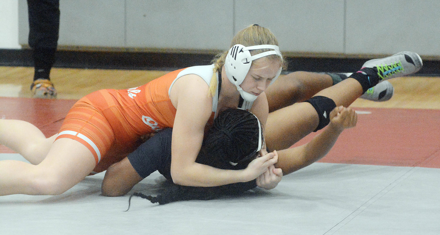 Bailee Dare (left) puts Miller Career Academy wrestler Michela Alexander on her back before winning her quarterfinal match by fall at 170 pounds in :19 during the Missouri State High School Activities Association (MSHSAA) Class 1, District Girls Wrestling Tournament at St Clair High School.